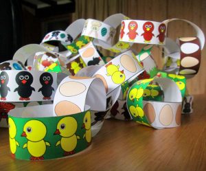 A pile of Easter Paper chains decorated with chicks and binnies - free to print out.