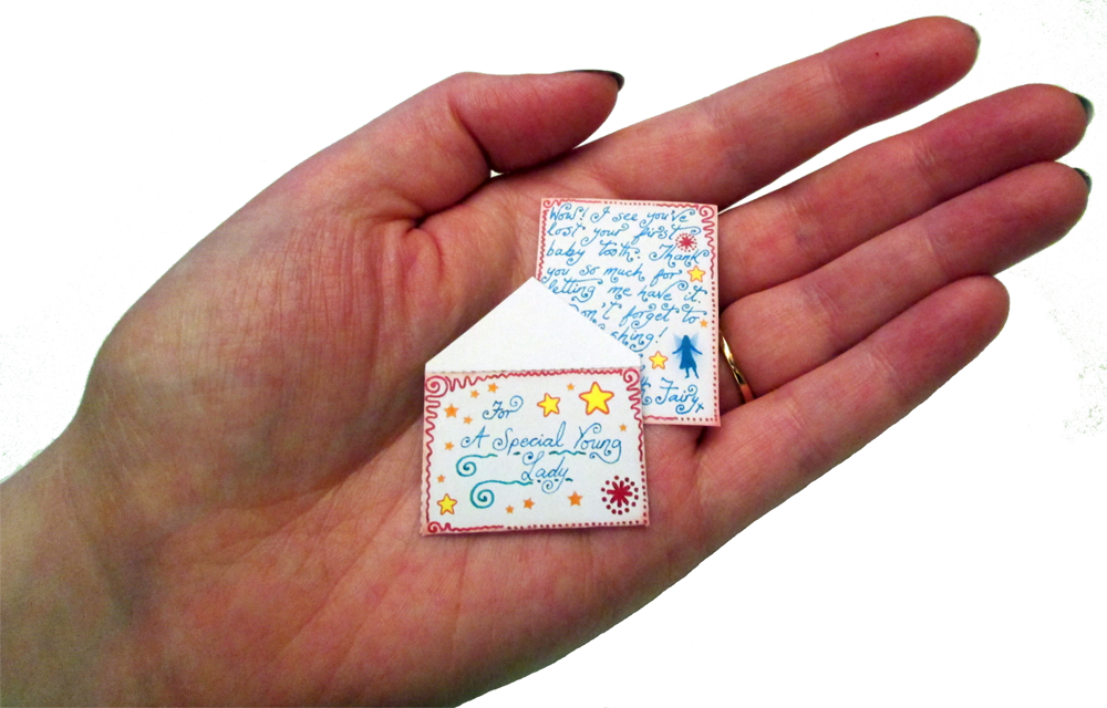 A miniature Tooth Fairy letter with a matching envelope for a little girl.