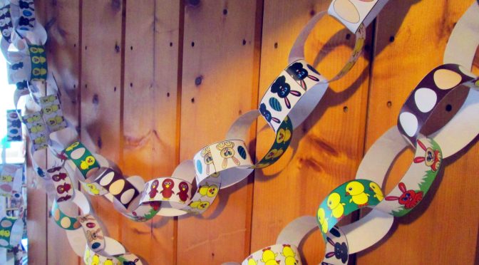 A line of our Easter paper chains linked together and hanging up.