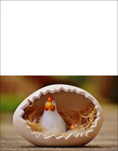 A printable Easter card picturing a china hen and her chick inside an egg.